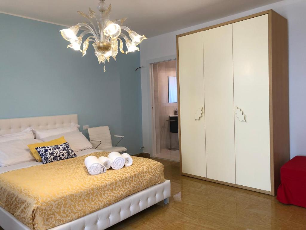 a bedroom with a bed with two towels on it at Grazia's Apartment in Chioggia