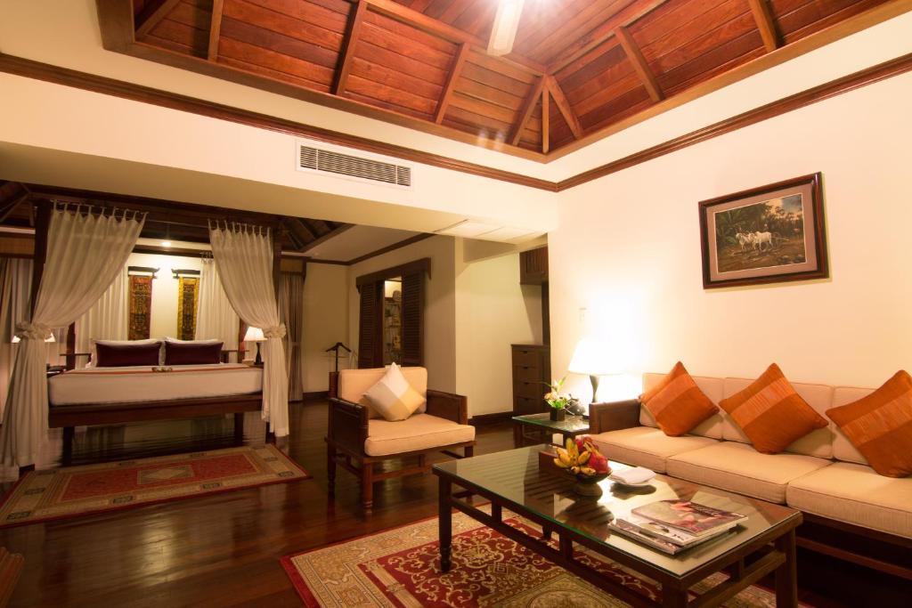 a living room with a couch and a piano at Palace Residence & Villa Siem Reap in Siem Reap