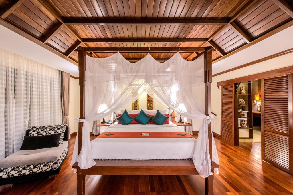 a bedroom with a bed with a canopy at Palace Residence & Villa Siem Reap in Siem Reap