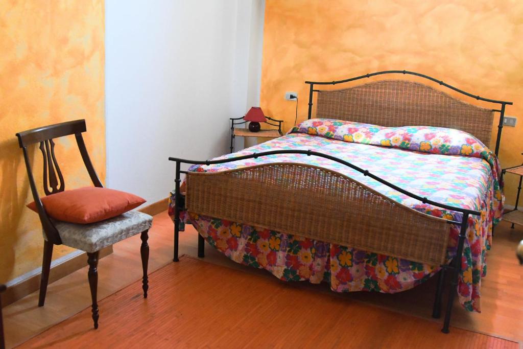 a bedroom with a bed and a chair in it at B&B A Casa di Sara in Pescantina