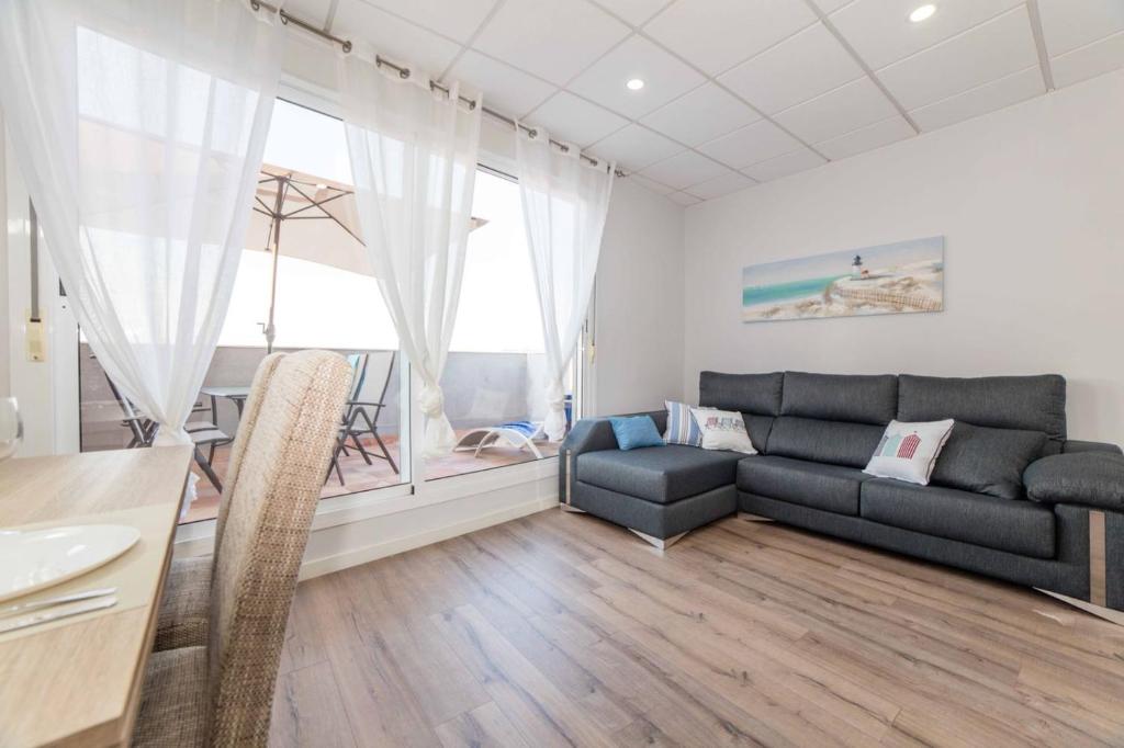 a living room with a couch and a table at Apartamento Constancia in Sant Carles de la Ràpita