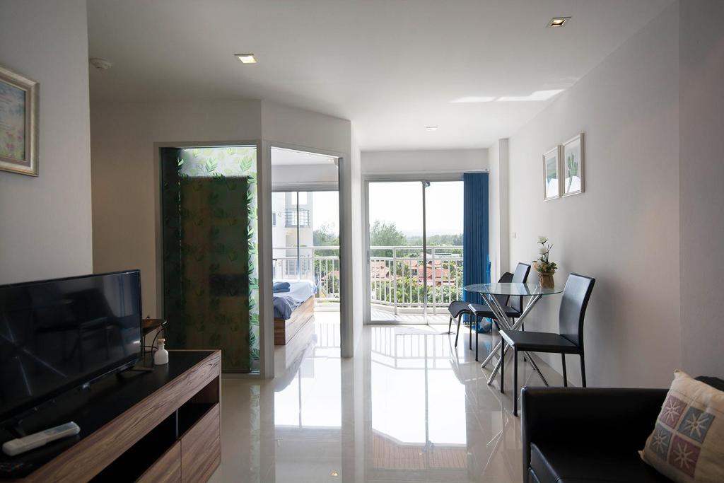 uma sala de estar com televisão e uma sala de jantar em Mosaic CondominiumA62M by malai em Mae Pim