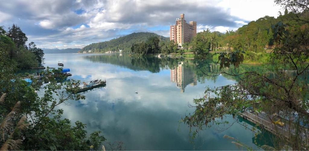 a large body of water with a building in the background at Miracolo View Hotel in Yuchi