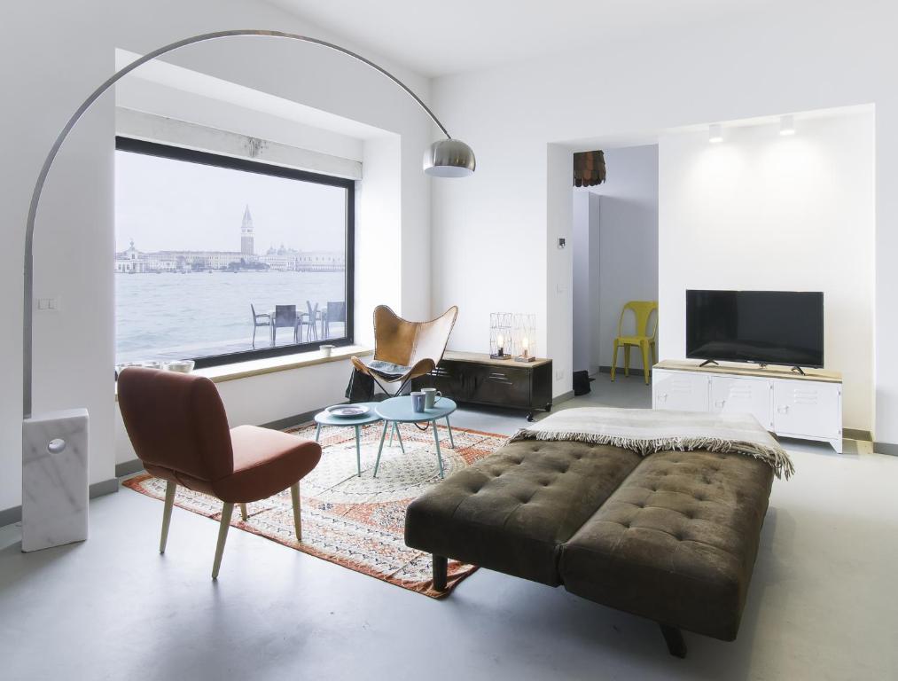 a living room with a bed and a large window at San Mark's basin best view in Venice