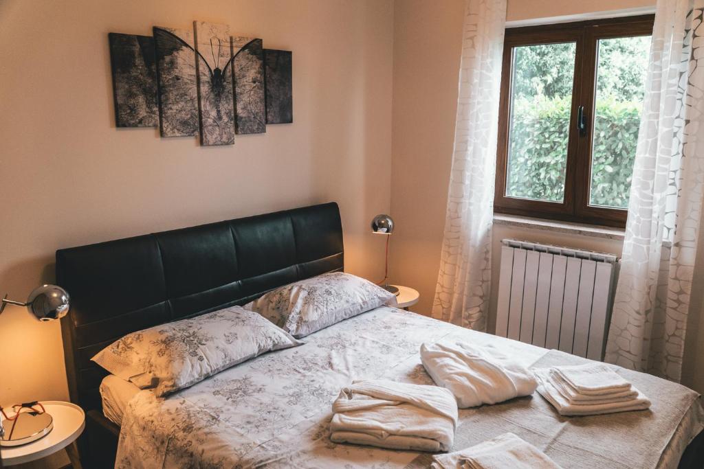 a bedroom with a bed with two pillows on it at Apartment Serenum in Matulji