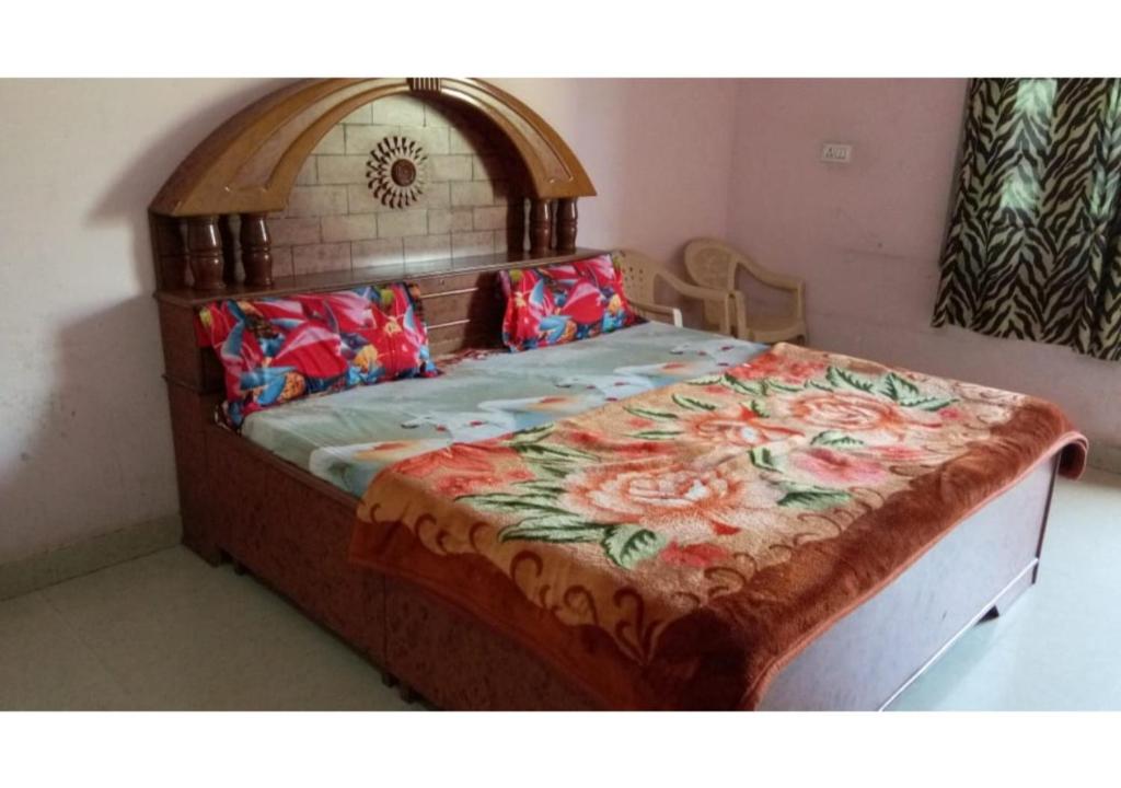 a bedroom with a large bed with a floral bedspread at Peaceful Palace in Pushkar in Pushkar