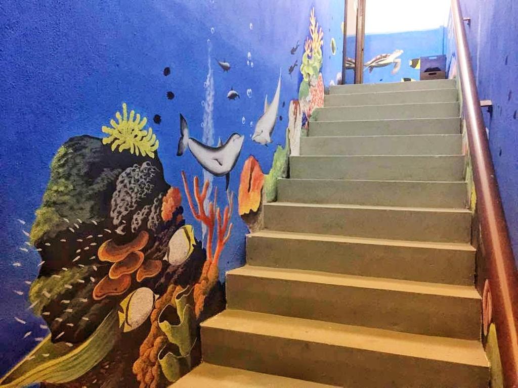 a mural of an underwater staircase in a school classroom at Coral Home 珊瑚之家 in Semporna