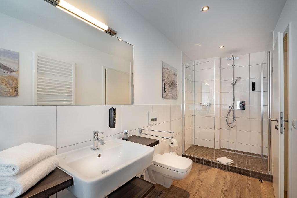 a bathroom with a sink and a toilet and a shower at Boutique Hotel Rose in Baden-Baden