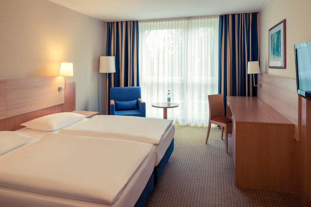 Postel nebo postele na pokoji v ubytování Mercure Hotel Schweinfurt Maininsel
