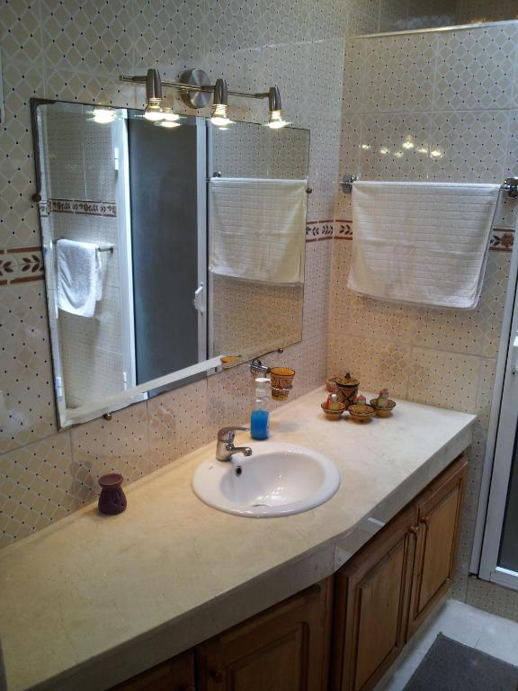 a bathroom with a sink and a mirror at Riad Dar Zouhour in Rabat