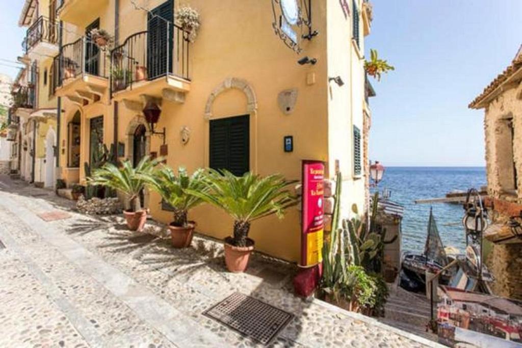 a street with potted plants in front of a building at Le Piccole Grotte in Scilla