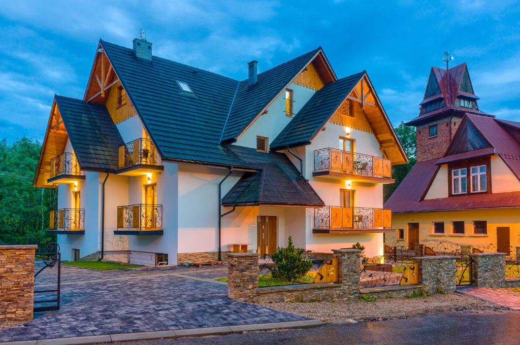 a large house with a black roof at Willa Na Skarpie in Szczawnica