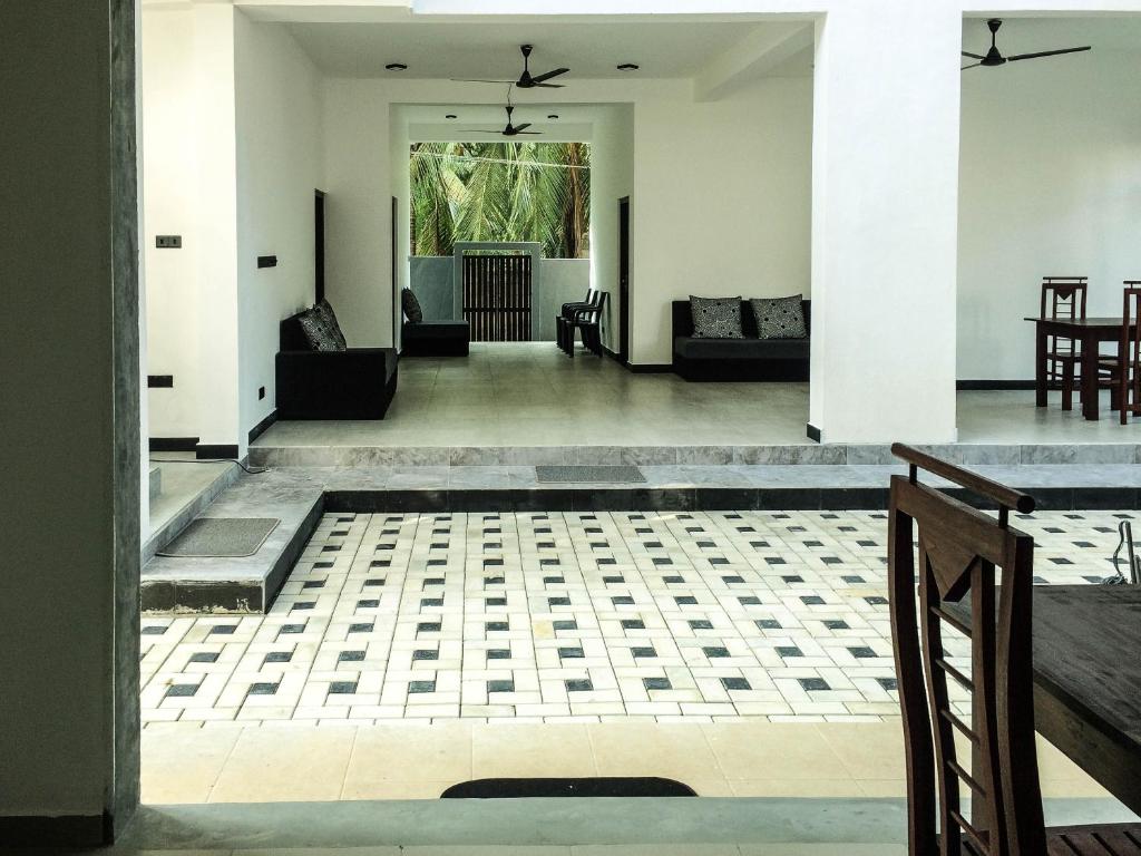 an open living room with white walls and a tile floor at Opal Mirissa in Mirissa