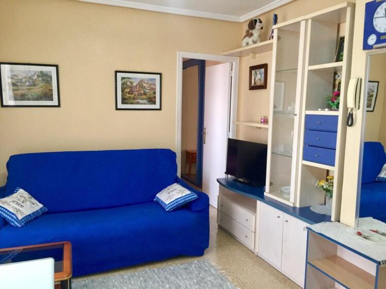 トレビエハにあるApartments atico on Calle Caballero de Rodasのリビングルーム(青いソファ、テレビ付)