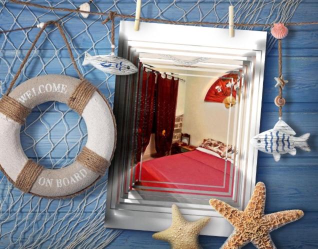 a mirror on a blue wall with starfish and a bedroom at Casa Olbia 2 in Olbia