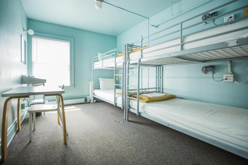 a room with two bunk beds and a desk at American Hotel Hostel in Seattle