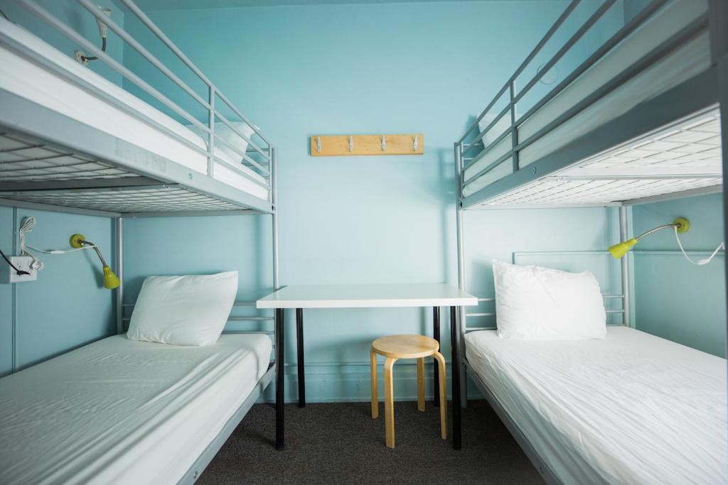Postel nebo postele na pokoji v ubytování American Hotel Hostel
