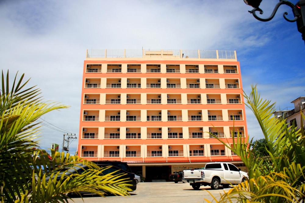 a white truck parked in front of a large building at P.A. Ville Hotel in Nakhon Sawan