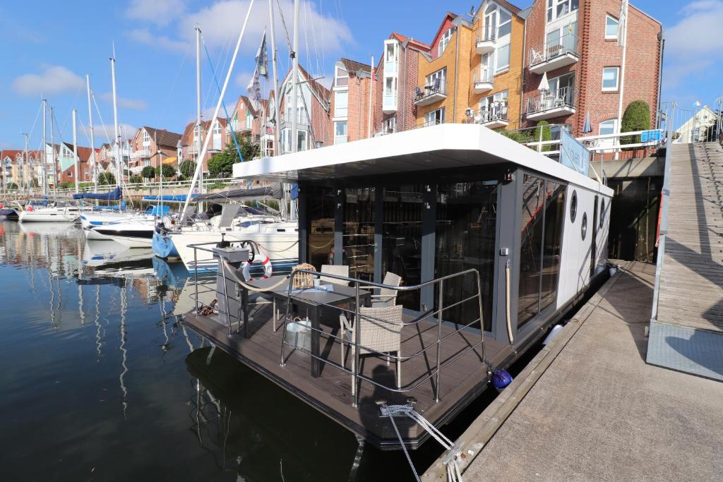 a boat is docked at a marina with buildings at Havenkoje in Cuxhaven