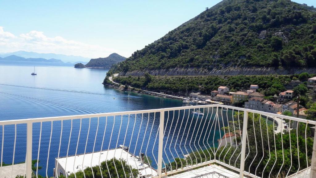 a view of a body of water with a mountain at Apartmani Marija Mljet in Sobra