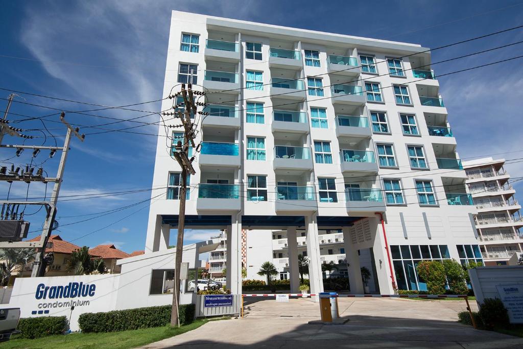 a large white building with blue windows at Grandblue Condo 410 in Mae Pim