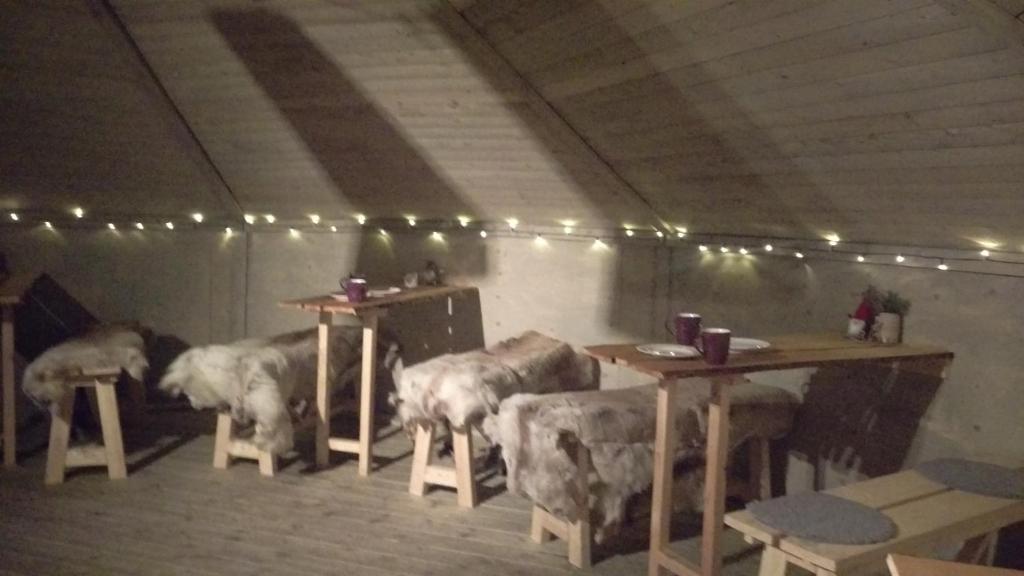 a group of elephants standing in a room with tables and chairs at JVT Cabins in Kiruna