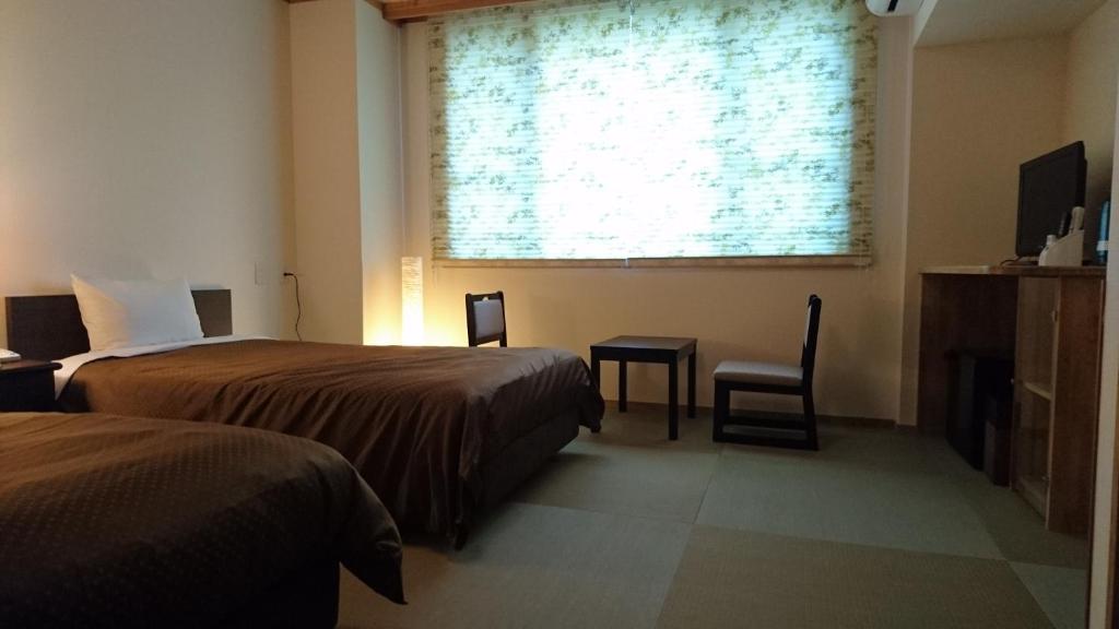 Postel nebo postele na pokoji v ubytování Hotel Oak Forest