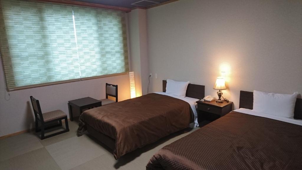 Postel nebo postele na pokoji v ubytování Hotel Oak Forest