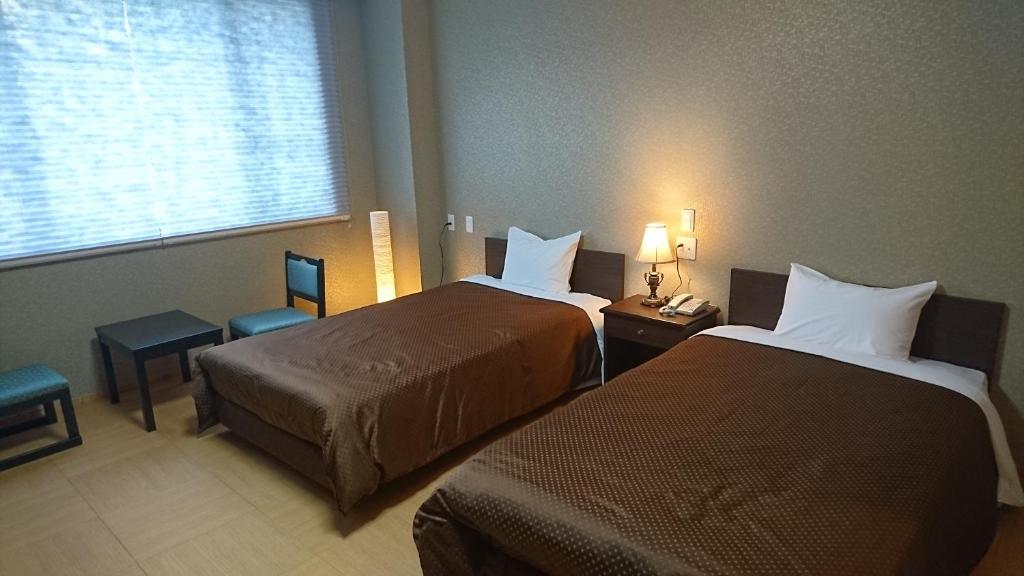 Postel nebo postele na pokoji v ubytování Hotel Oak Forest