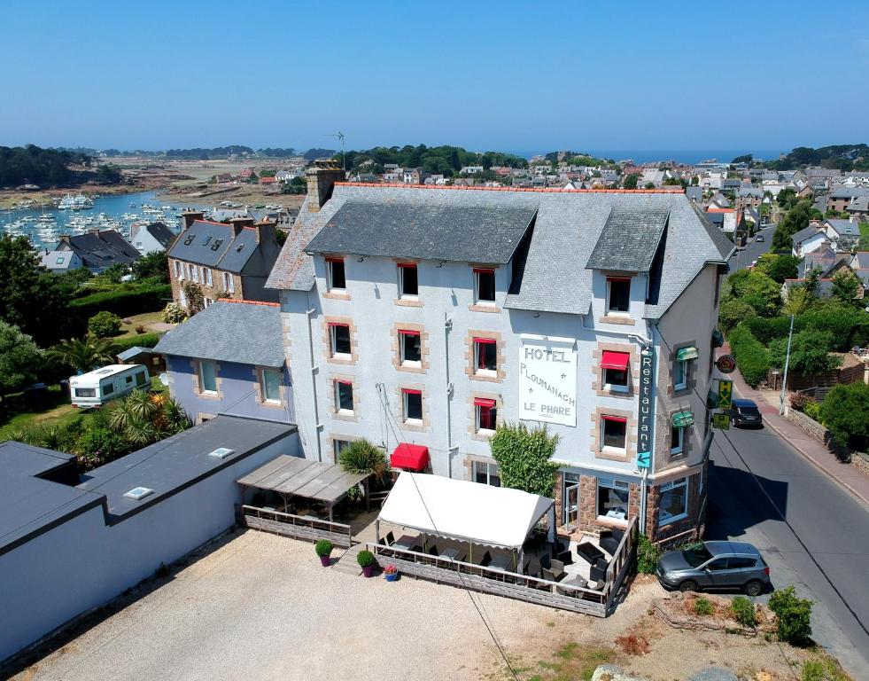 an aerial view of a white building with a store at Hotel Restaurant Le Phare in Perros-Guirec