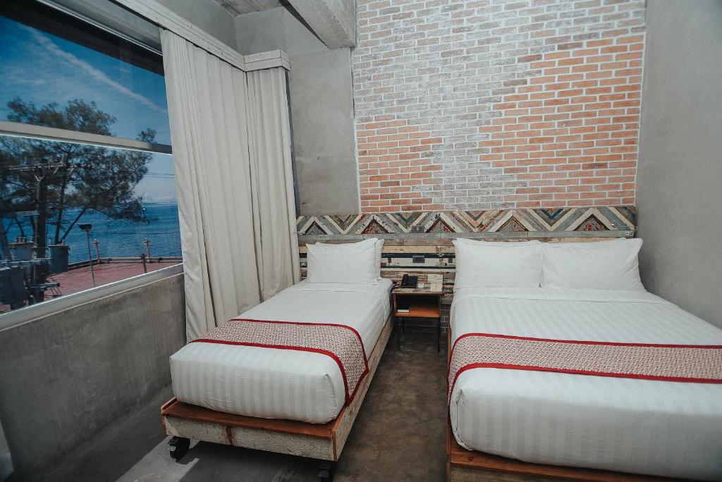 Postel nebo postele na pokoji v ubytování The Bricks Hotel