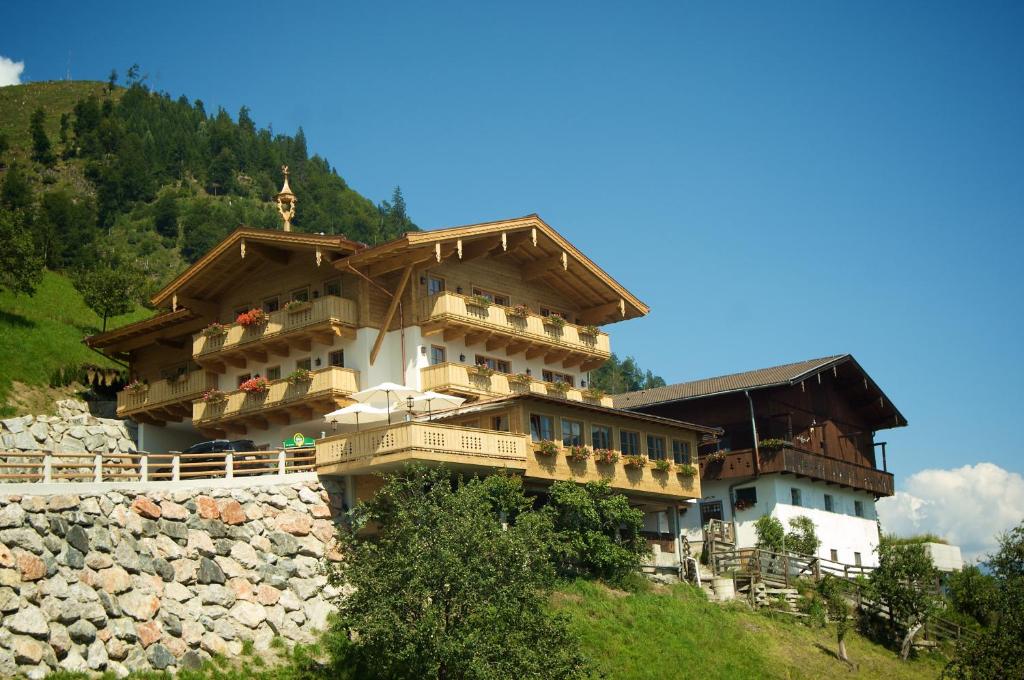 a large building on top of a mountain at Jausenstation Pfefferbauer in Zell am See