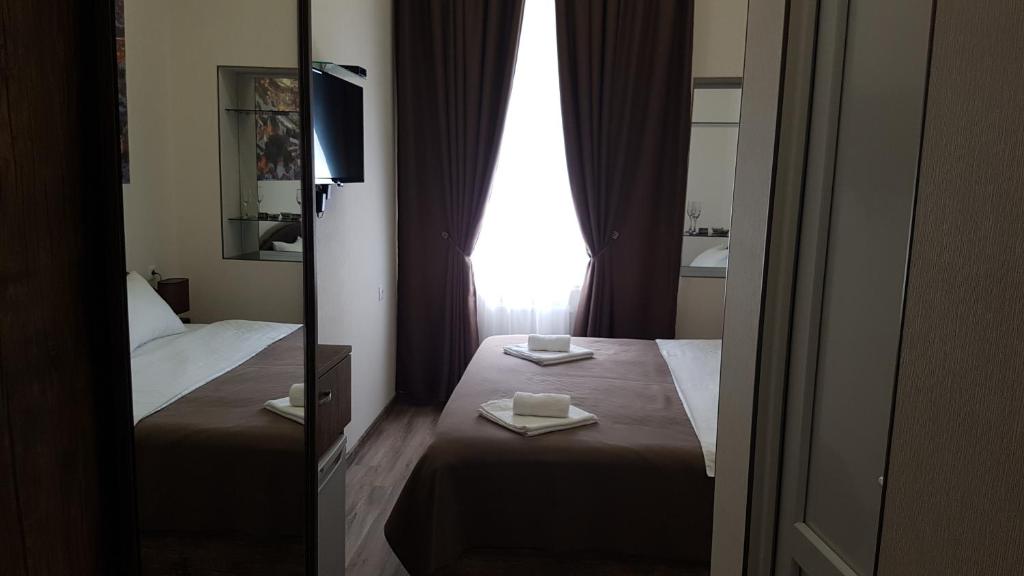 Postel nebo postele na pokoji v ubytování Sweet Rooms Inn