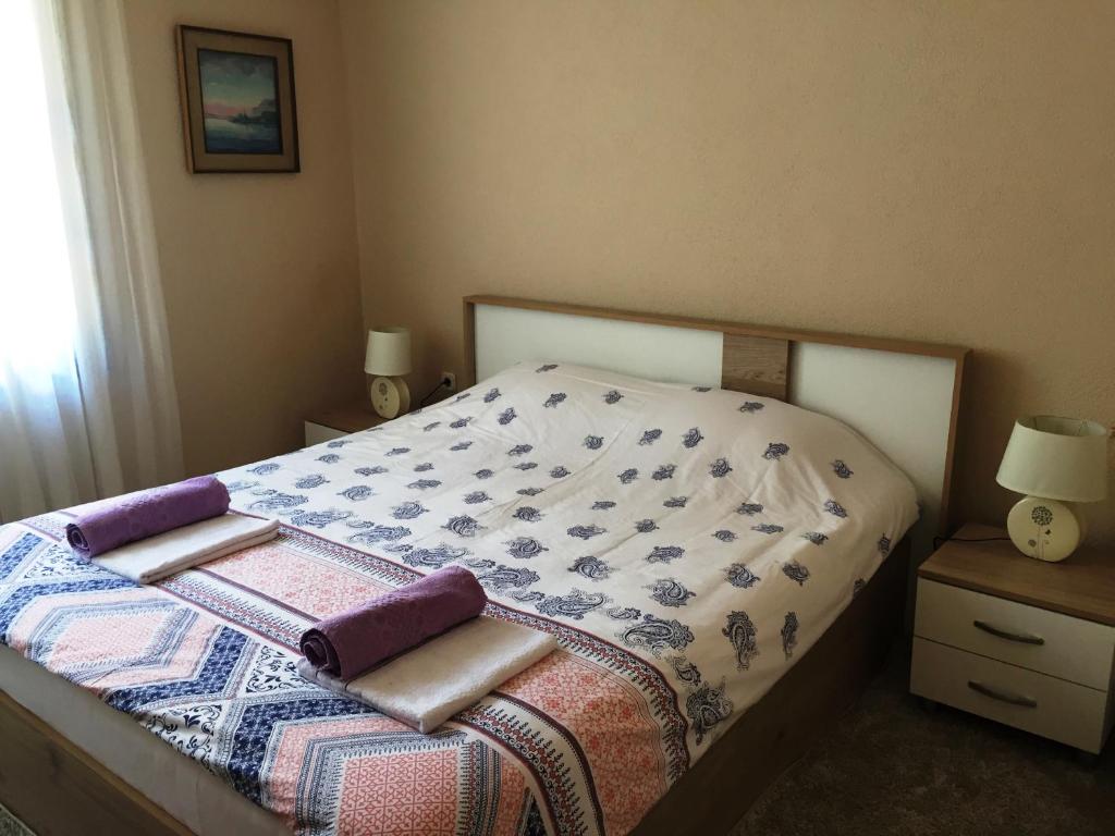 a bedroom with a bed with a comforter on it at Sofia Apartment in Ohrid