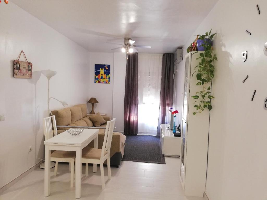 a living room with a table and a couch at APplaya in El Puerto de Santa María