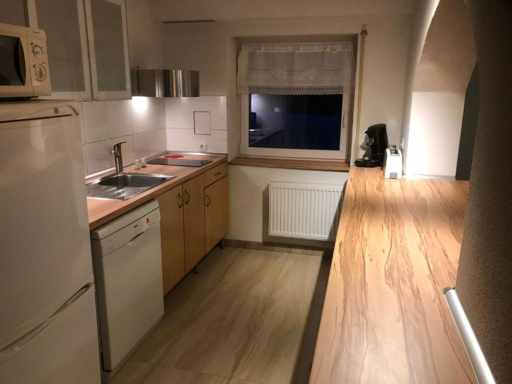 a small kitchen with a sink and a refrigerator at Ferienwohnung Rose in Villingen-Schwenningen