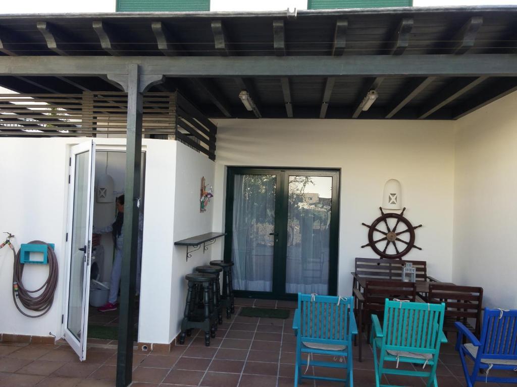 プラヤ・ブランカにあるCasa Luz 143, Residencial el Pueblitoのパティオ(青い椅子、壁掛け車付)