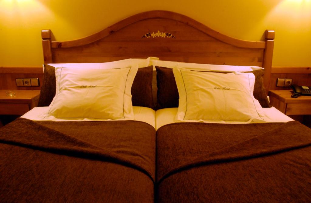 Postel nebo postele na pokoji v ubytování Petit Hotel