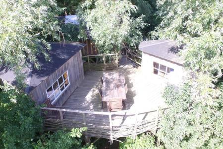 an overhead view of a house with a deck at Treehouse B&B in Rabjerg