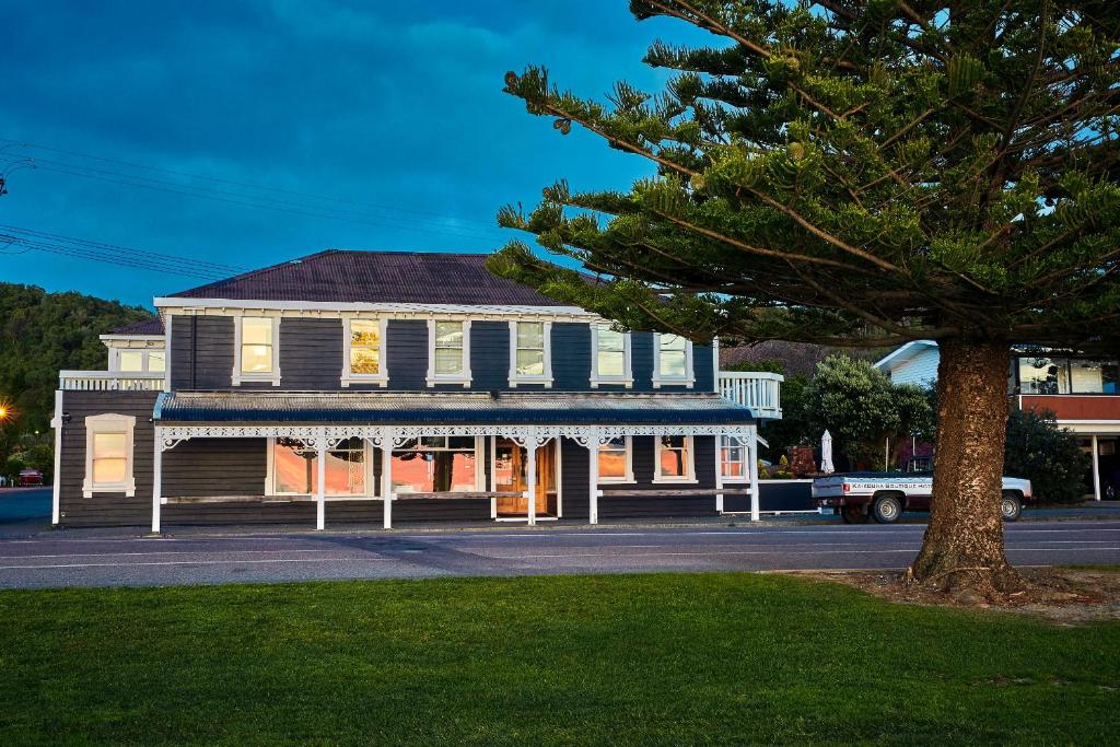 
a large building with a tree in front of it at Kaikoura Boutique Hotel in Kaikoura
