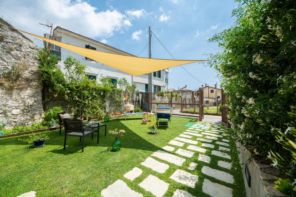 un patio trasero con una hamaca amarilla colgando sobre él en casa vacanza sole, en Tramonti
