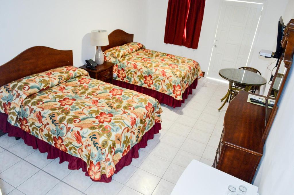 a hotel room with two beds and a table at Fantastic Hotel in Marigot