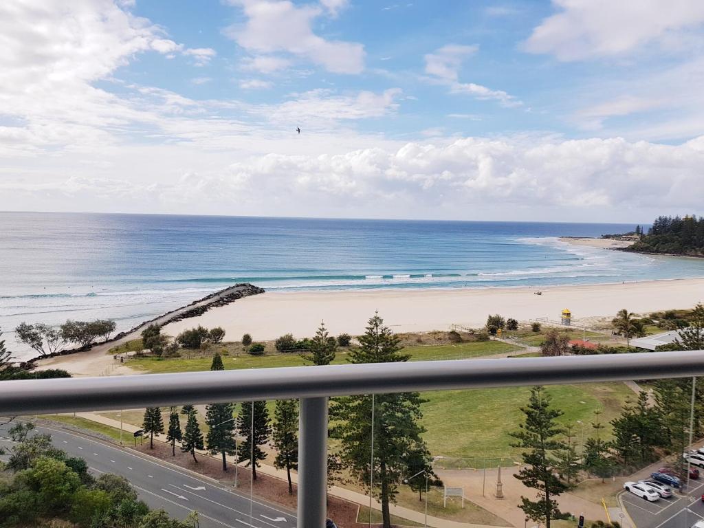 a view of the beach from the balcony of a condo at Blue C Coolangatta in Gold Coast