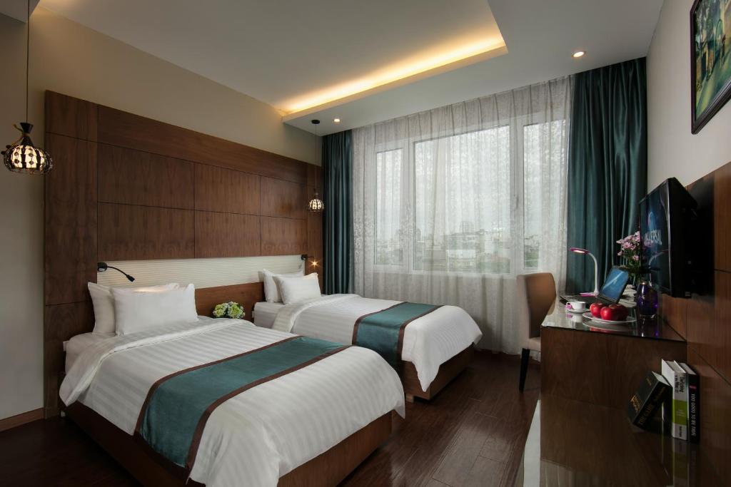 Postel nebo postele na pokoji v ubytování Bonne Nuit Hotel & Spa Hanoi