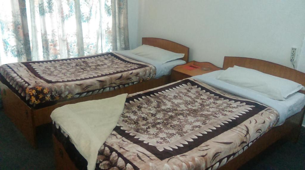 Postel nebo postele na pokoji v ubytování Hotel Down Town