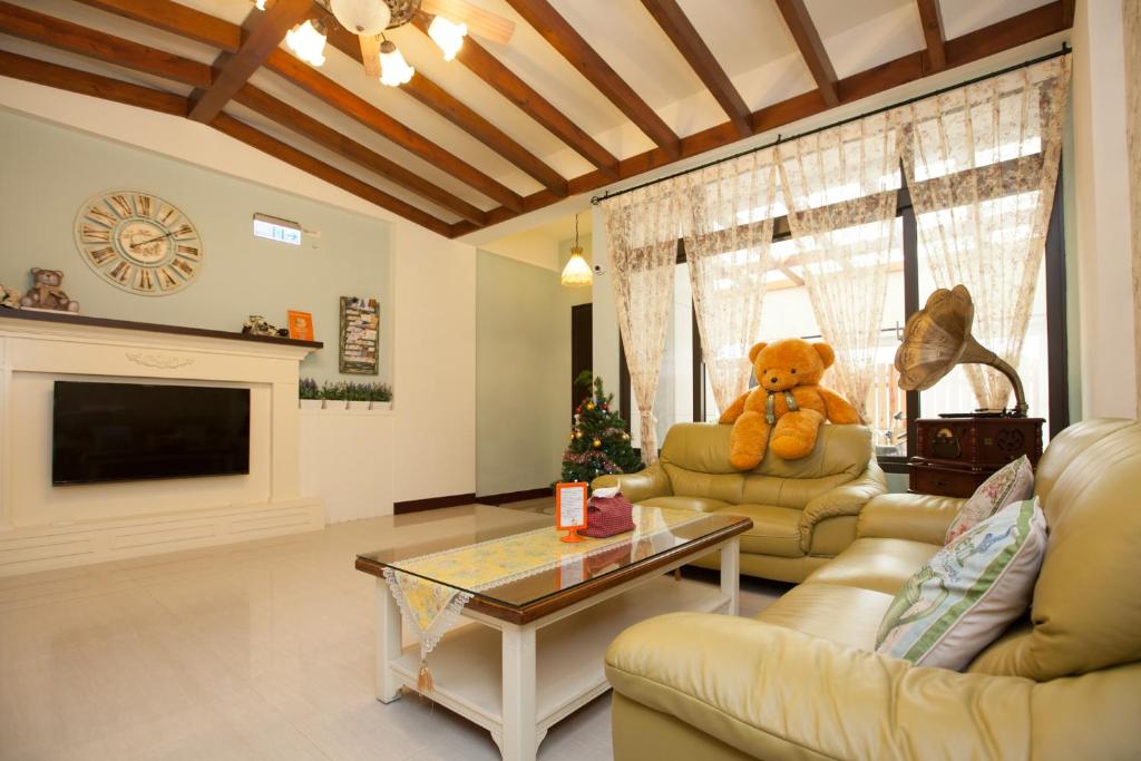 a living room with a teddy bear sitting on a couch at Happiness Homestay in Hualien City
