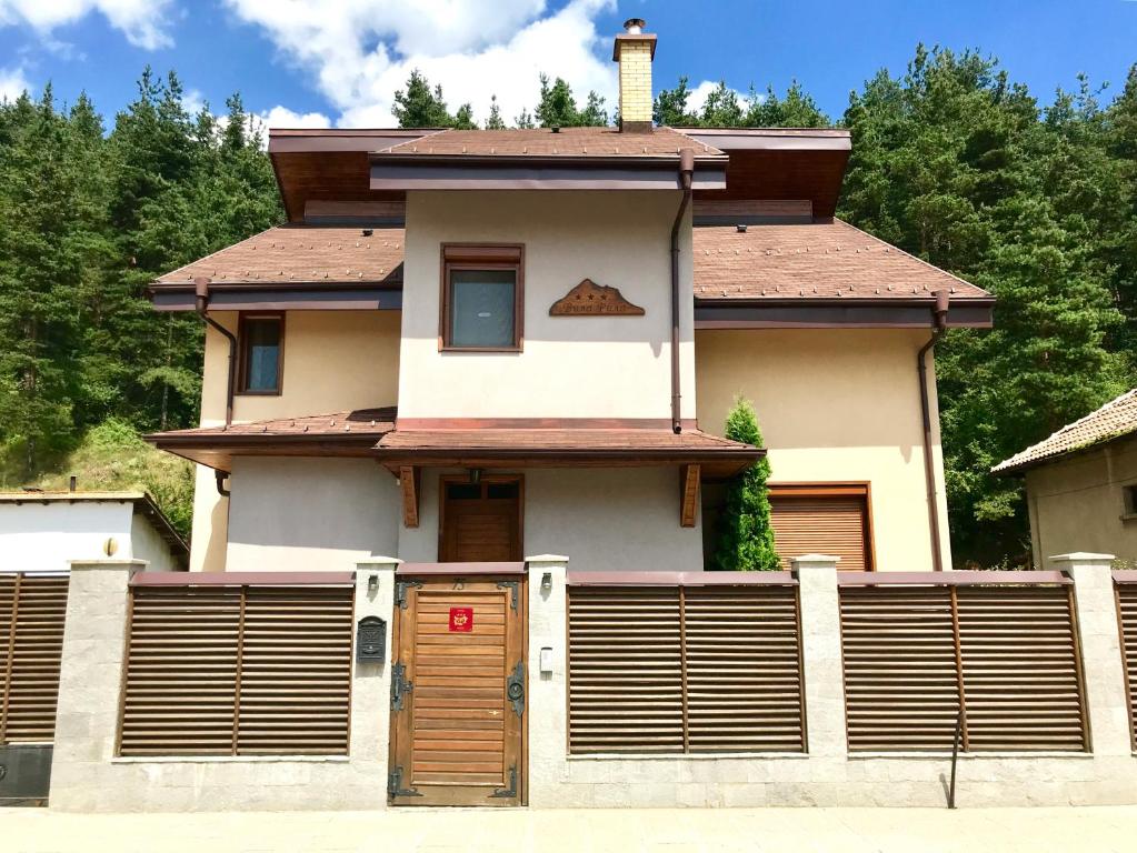 a house with a fence in front of it at Vila Rila Samokov in Samokov