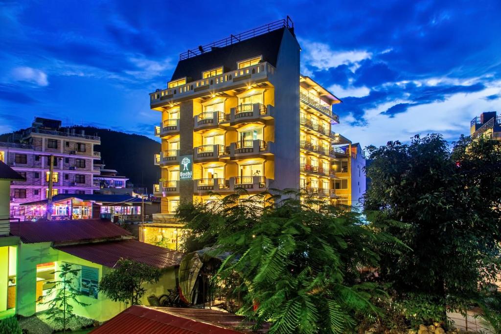a hotel in the middle of a city at night at Bodhi Suites Boutique Hotel and Spa in Pokhara