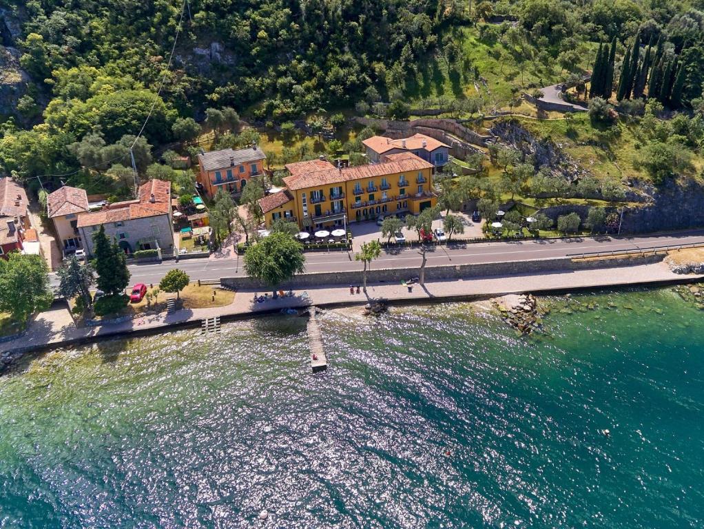 an aerial view of a building next to the water at Albergo Del Garda in Torri del Benaco
