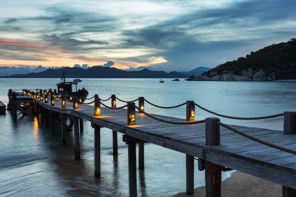 a dock with lights on it in the water at Six Senses Ninh Van Bay in Ninh Van Bay